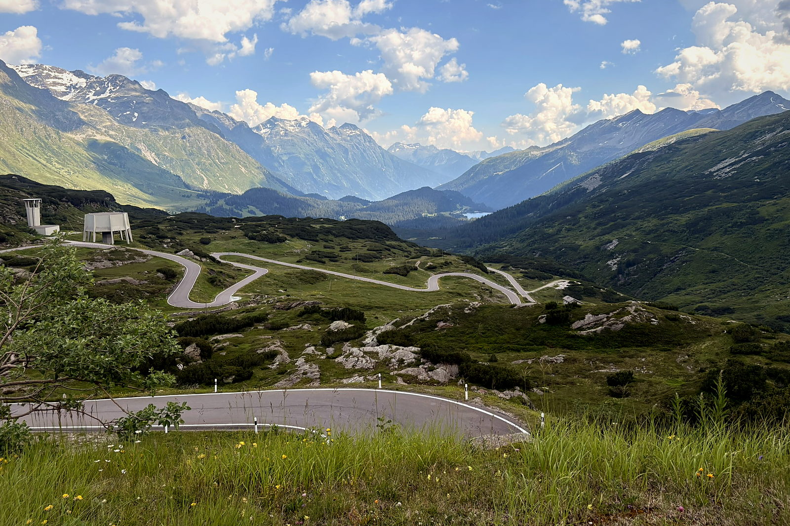 The San Bernardino pass road curving through a wide green valley