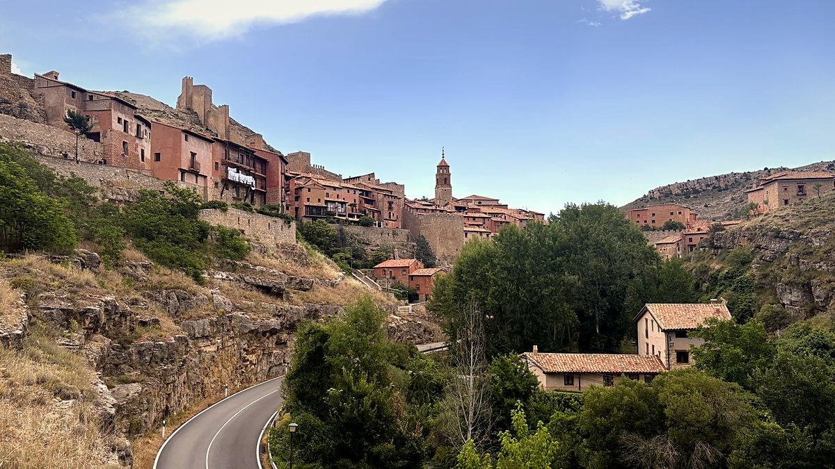 The red-stone old town of Albarracín above a curving valley road